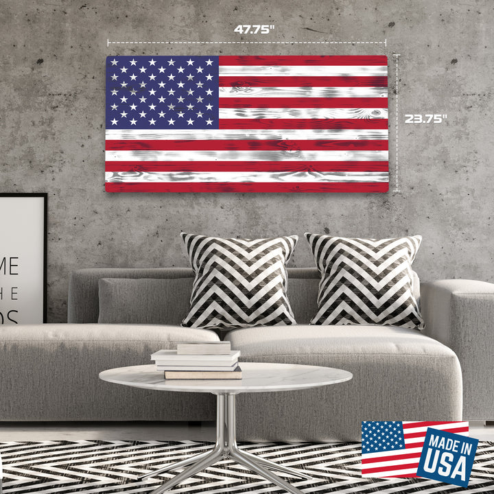 Living room with American flag wall art, gray sofa, and coffee table.